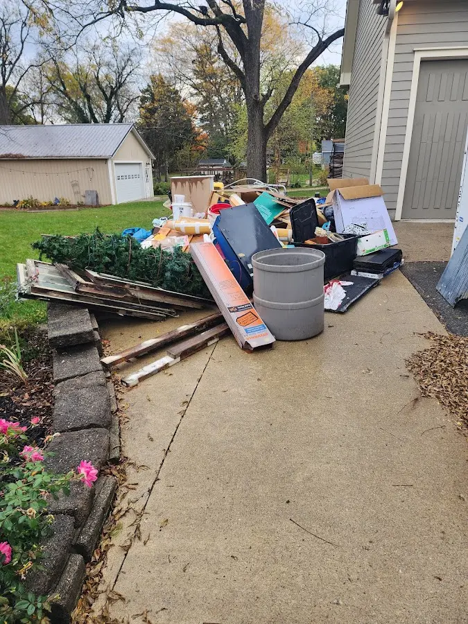 Dumpster being loaded with debris for Estate Cleanout Dumpster Rental in Amenia